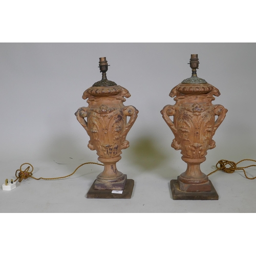 16 - A pair of vintage terracotta urn table lamps, with brass mounts, 51cm high