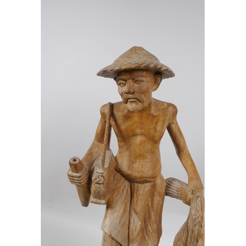 166 - An oriental carved wood figure of a farmer surrounded by ducks, 46cm high