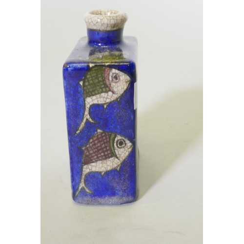 167 - An Iznik ceramic flask decorated with fish on a blue glaze, 15cm high