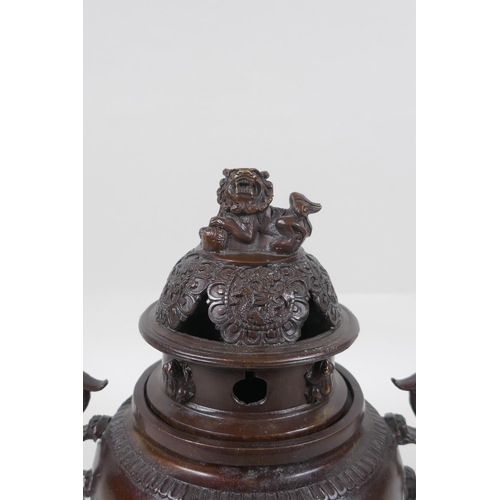 175 - A Chinese bronze two handled censer and cover on tripod feet, with kylin decoration and knop, impres... 