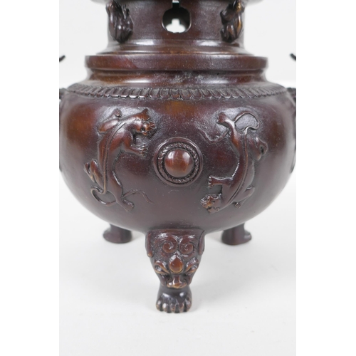 175 - A Chinese bronze two handled censer and cover on tripod feet, with kylin decoration and knop, impres... 