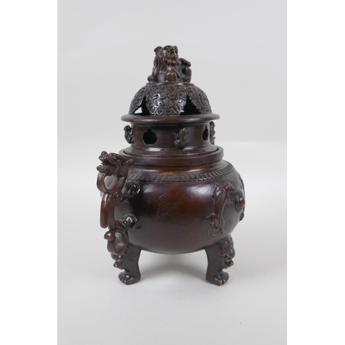 175 - A Chinese bronze two handled censer and cover on tripod feet, with kylin decoration and knop, impres... 