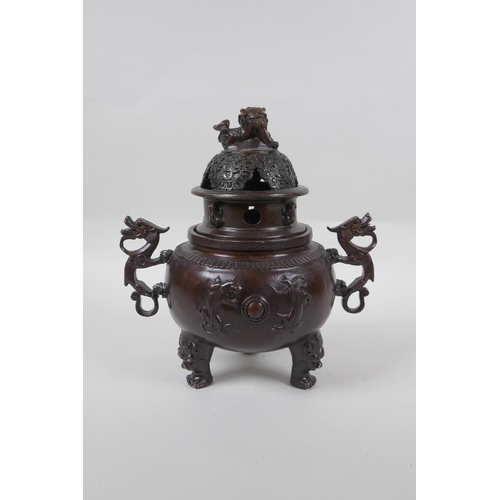 175 - A Chinese bronze two handled censer and cover on tripod feet, with kylin decoration and knop, impres... 