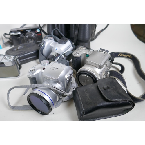 182 - A collection of cameras and equipment, to include an Olympus PEN-EE, an Olympus Trip 35, an Olympus ... 