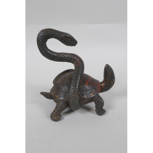 206 - A Chinese bronze figure of a tortoise and snake entwined with each other, with the remnants of gilt ... 