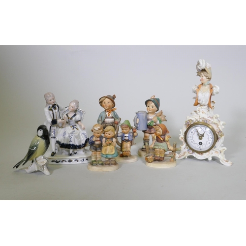 21 - Continental porcelain figures, five Goebel (one AF), a figure group, Karl End bird and a clock with ... 