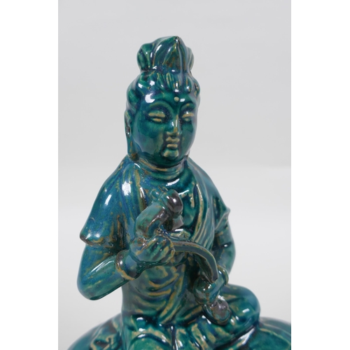 210 - A Chinese teal glazed porcelain Guan Yin, mark to base, 21cm high