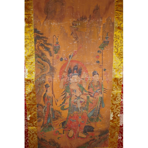 211 - A Tibetan printed thangka with a silk mount, 110 x 65cm