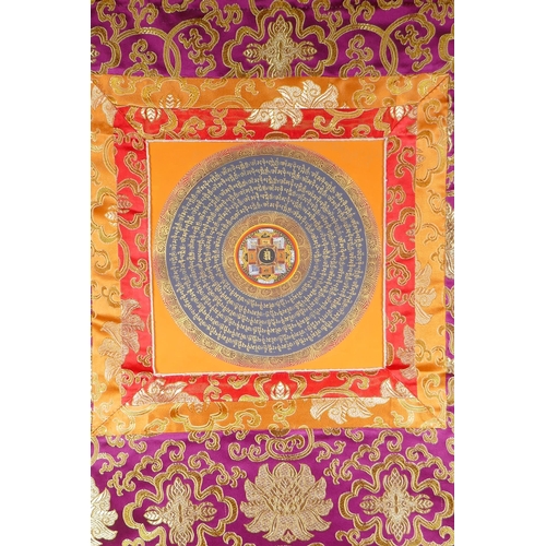 234 - A Tibetan hand painted mandala within a silk mount, 66 x 52cm