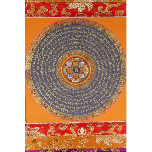 234 - A Tibetan hand painted mandala within a silk mount, 66 x 52cm