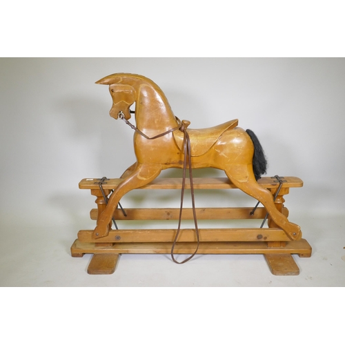 24 - A vintage pine rocking horse with carved saddle, 107cm high, 144cm long