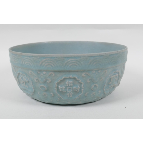 243 - A Chinese Ru ware style bowl with raised character marks and carp decoration, 21cm diameter