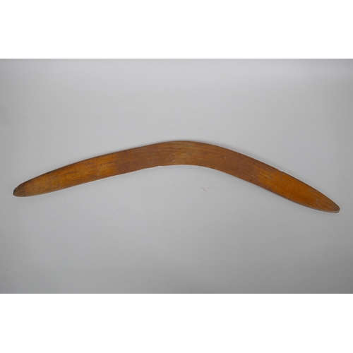 244 - An Australian carved wood boomerang, 66cm