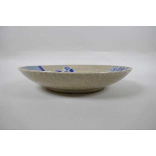 250 - A Chinese blue and white crackleware dish decorated with boys playing in a garden, 26cm diameter