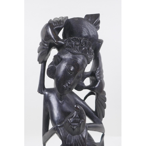 256 - A Balinese carved hardwood figure of a dancer, 45cm high