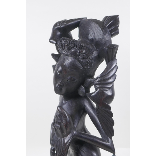 256 - A Balinese carved hardwood figure of a dancer, 45cm high