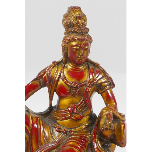 260 - A Chinese bronze figure of Quan Yin with gilt and red lacquer patina, 21cm high