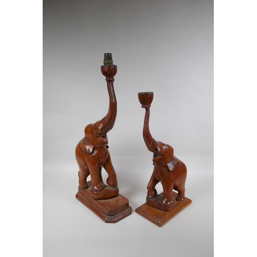 262 - A near pair of carved wood elephants, drilled and part converted for lamps, 57cm high