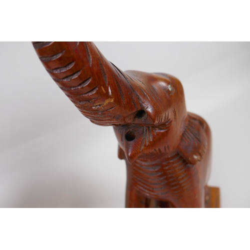 262 - A near pair of carved wood elephants, drilled and part converted for lamps, 57cm high