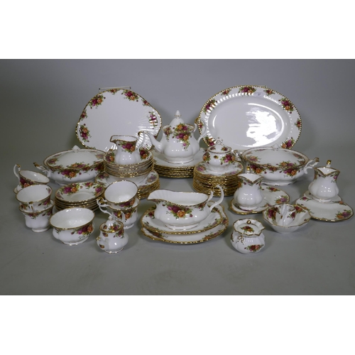 27 - A Royal Albert Country Rose six place dinner service, with serving plates, tureens etc, appears unus... 