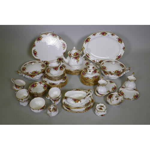 27 - A Royal Albert Country Rose six place dinner service, with serving plates, tureens etc, appears unus... 