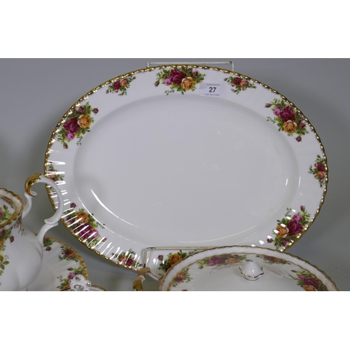 27 - A Royal Albert Country Rose six place dinner service, with serving plates, tureens etc, appears unus... 