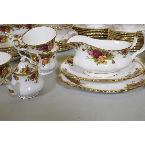 27 - A Royal Albert Country Rose six place dinner service, with serving plates, tureens etc, appears unus... 