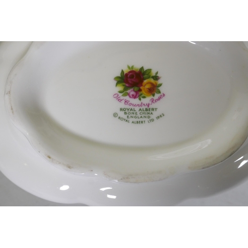 27 - A Royal Albert Country Rose six place dinner service, with serving plates, tureens etc, appears unus... 