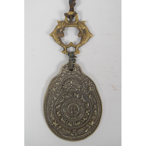 270 - A Tibetan bronze and silvered metal calendar pendant, together with a bronze figure of a jolly Buddh... 