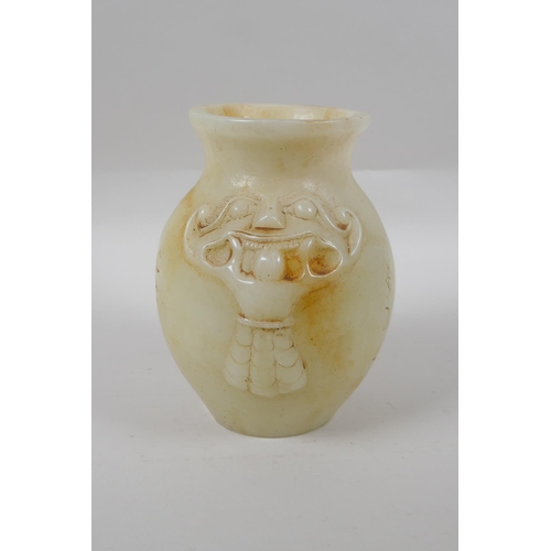 273 - A Chinese reconstituted hardstone jar with twin mask decoration, 17cm high