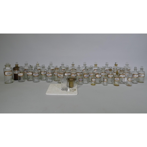 3 - A collection of Victorian glass apothecary bottles, all with stoppers and inset gilt labels, largest... 