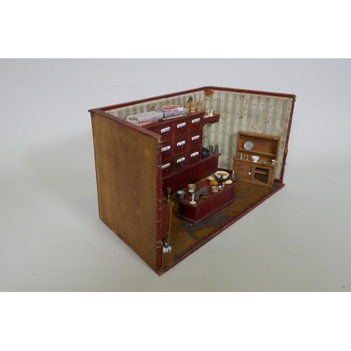 4 - An antique model of a sweet shop, with opening drawers and counter, late C19th/early C20th, 62 x 30 ... 