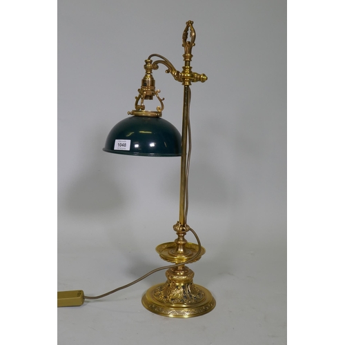 41 - An ormolu table lamp with adjustable painted toleaware shade, the base with fine engraved and pierce... 