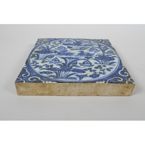 43 - A Chinese blue and white porcelain temple tile decorated with waterfowl in a lotus pond, 20 x 20cm