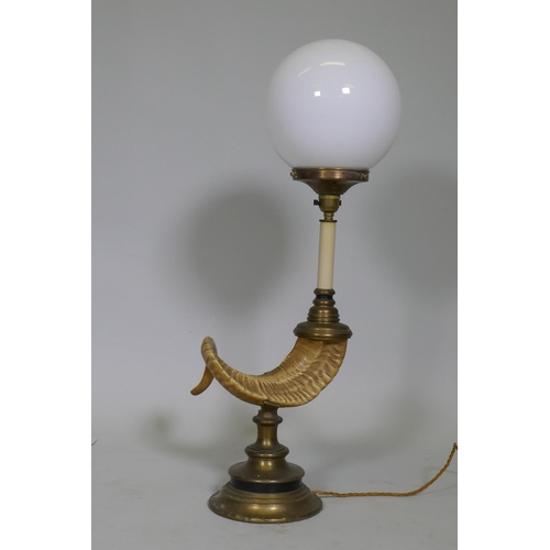 46 - A table lamp in the form of a ram's horn, with brass mounts and opaline glass shade, 68cm high