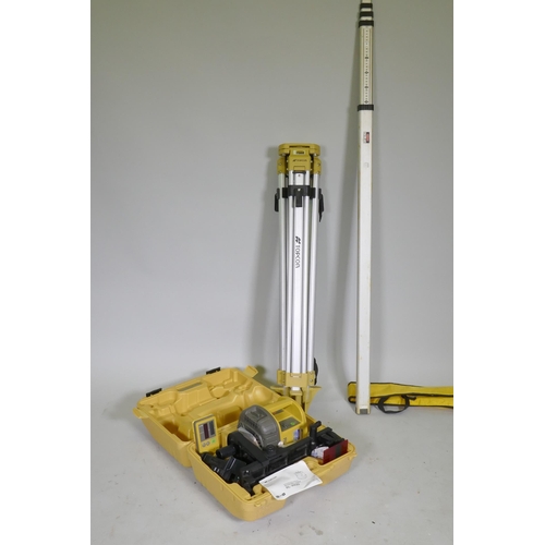 57 - A Topcon RL-VH3D Rotating surveyor's laser, with tripod and staff