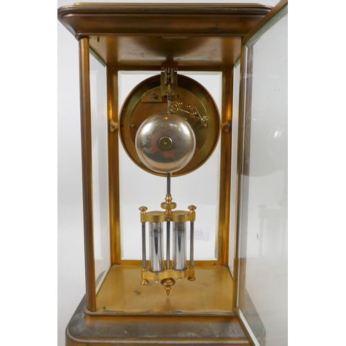 602 - A C19th French brass mantel clock with a mercury pendulum and enamelled chapter ring with Roman nume... 