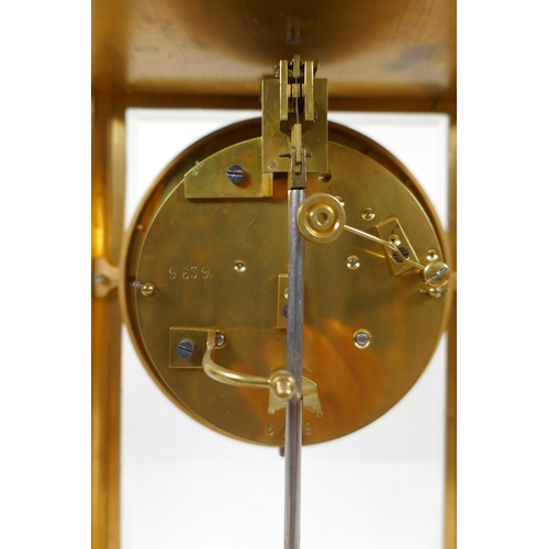 602 - A C19th French brass mantel clock with a mercury pendulum and enamelled chapter ring with Roman nume... 