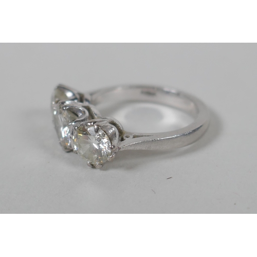 608 - A platinum set three brilliant cut diamond ring, the central stone approx 0.95ct, flanking two stone... 