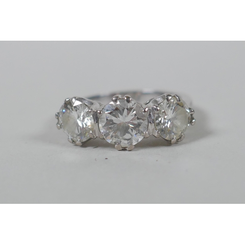 608 - A platinum set three brilliant cut diamond ring, the central stone approx 0.95ct, flanking two stone... 