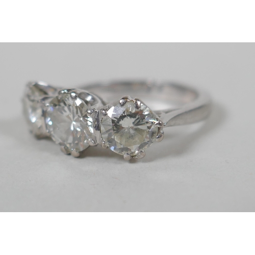 608 - A platinum set three brilliant cut diamond ring, the central stone approx 0.95ct, flanking two stone... 