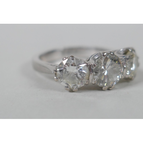 608 - A platinum set three brilliant cut diamond ring, the central stone approx 0.95ct, flanking two stone... 