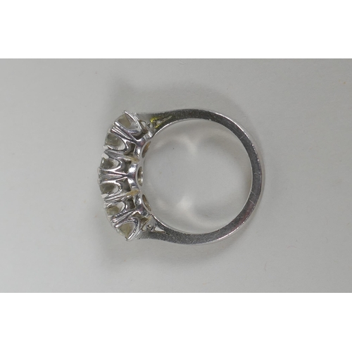 608 - A platinum set three brilliant cut diamond ring, the central stone approx 0.95ct, flanking two stone... 