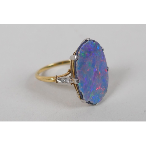 609 - A vintage yellow metal ring set with a fire opal veneered stone and diamond shoulders, together with... 