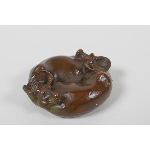 61 - An oriental cast bronze rondel in the form of two water buffalo and a Yin Yang emblem, 6cm diameter