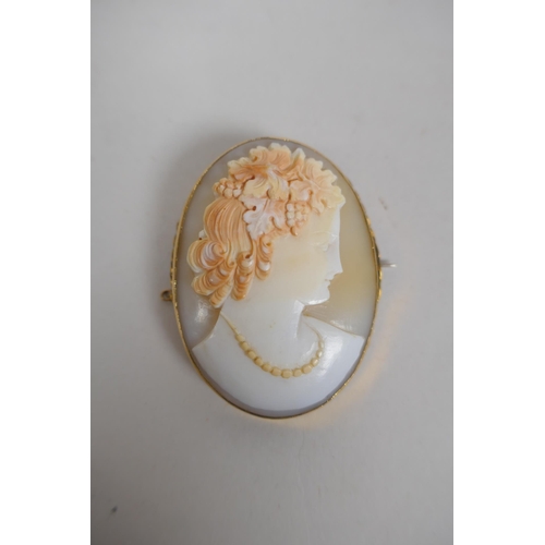 612 - An antique yellow metal mounted cameo brooch, and a pair of 9ct gold mounted cameo earrings, brooch ... 