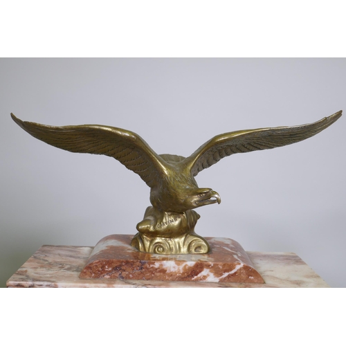 617 - A C19th French rouge marble clock with bronze mounts, the case surmounted by an eagle signed L. Caru... 