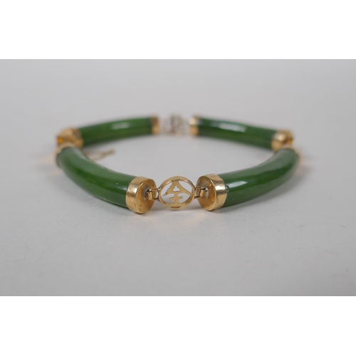 626 - A yellow metal mounted spinach jade bracelet decorated with Chinese characters, marked 14, 18cm long