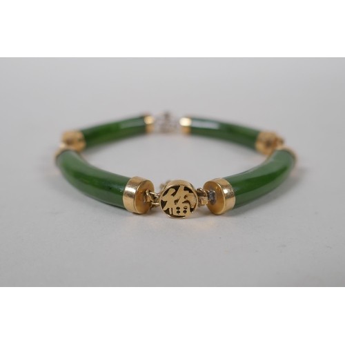 626 - A yellow metal mounted spinach jade bracelet decorated with Chinese characters, marked 14, 18cm long