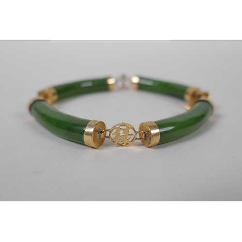 626 - A yellow metal mounted spinach jade bracelet decorated with Chinese characters, marked 14, 18cm long